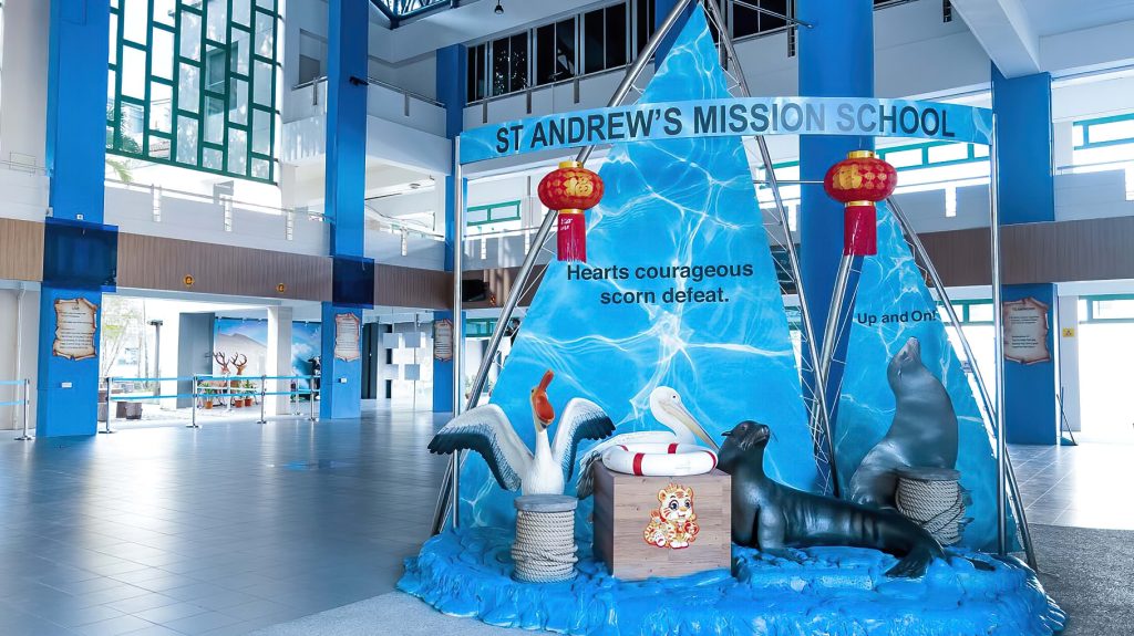 The school foyer, which contains a decorative piece. It features a set of sails with the school's name and motto, a pelican and a sea lion.